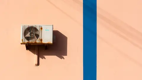 An Air Conditioner on a Wall with Blue Lines