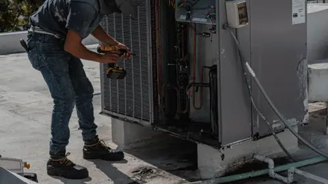 Repairman Repairing an Air Conditioner