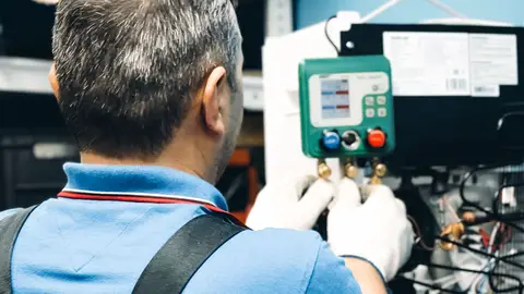 Technician Performing Air Conditioning Maintenance