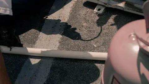 A Person Sitting on the Floor Holding a Unit Switch