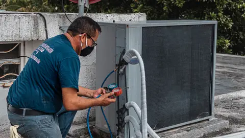 Man Checking an Air Conditioner