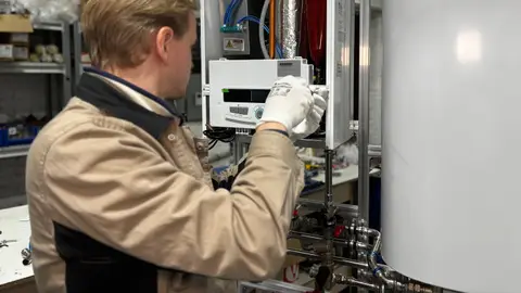 Technician Repairing Heating System in Workshop