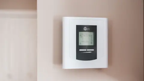 White Thermostat Hanging on the Wall