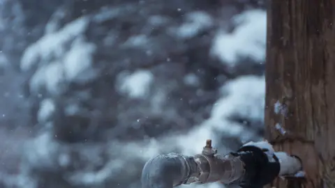 Outdoor Frozen Water Tap Dripping in Winter Scene