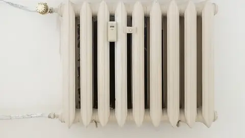White Steel Rib Radiator in a Bright Renovated Room