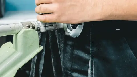 Plumber Repairing Pipe with Wrench Indoors