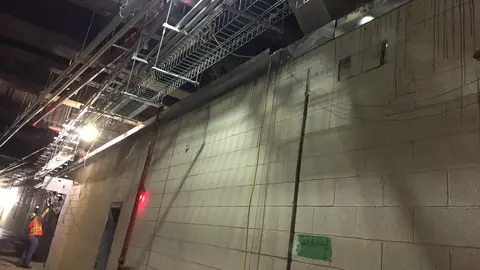 Installing gutters and wire racks in the back of house corridor in the future LIRR concourse. 06-25-2019 (48146739047)