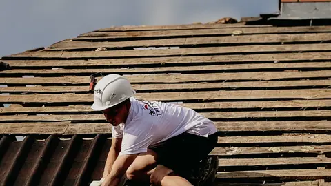 Roofer Working on Roof Installation with Safety Gear