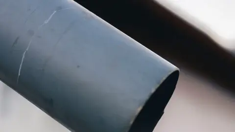 Close-up of Icicle on Metal Gutter in Winter