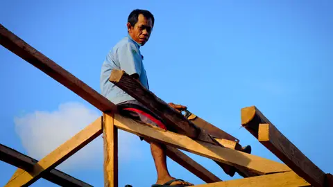 Carpenter Cutting a Roof Frame