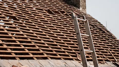 Rustic Roof Renovation with Chimney and Ladder