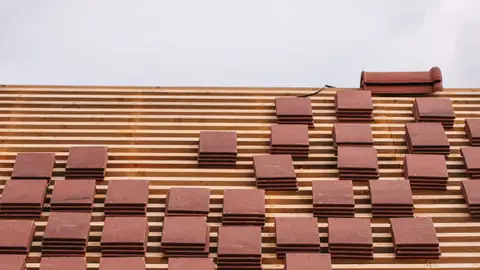 Installation of Red Clay Roof Tiles on New Building