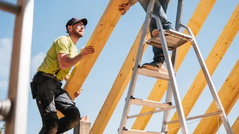 Roof Construction with Wooden Framework and Workers