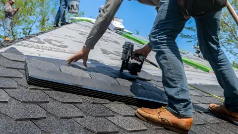 Professional Roofer Installing Shingles on New Roof