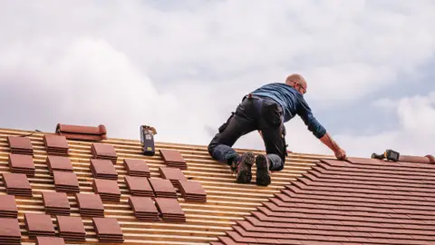Roofer Working on New House Roof Installation