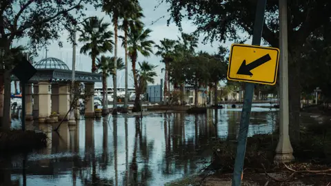 A Street Sign near the Flooded Road