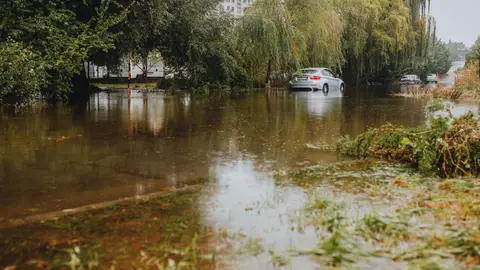 Car Navigating Flooded Road in Urban Area