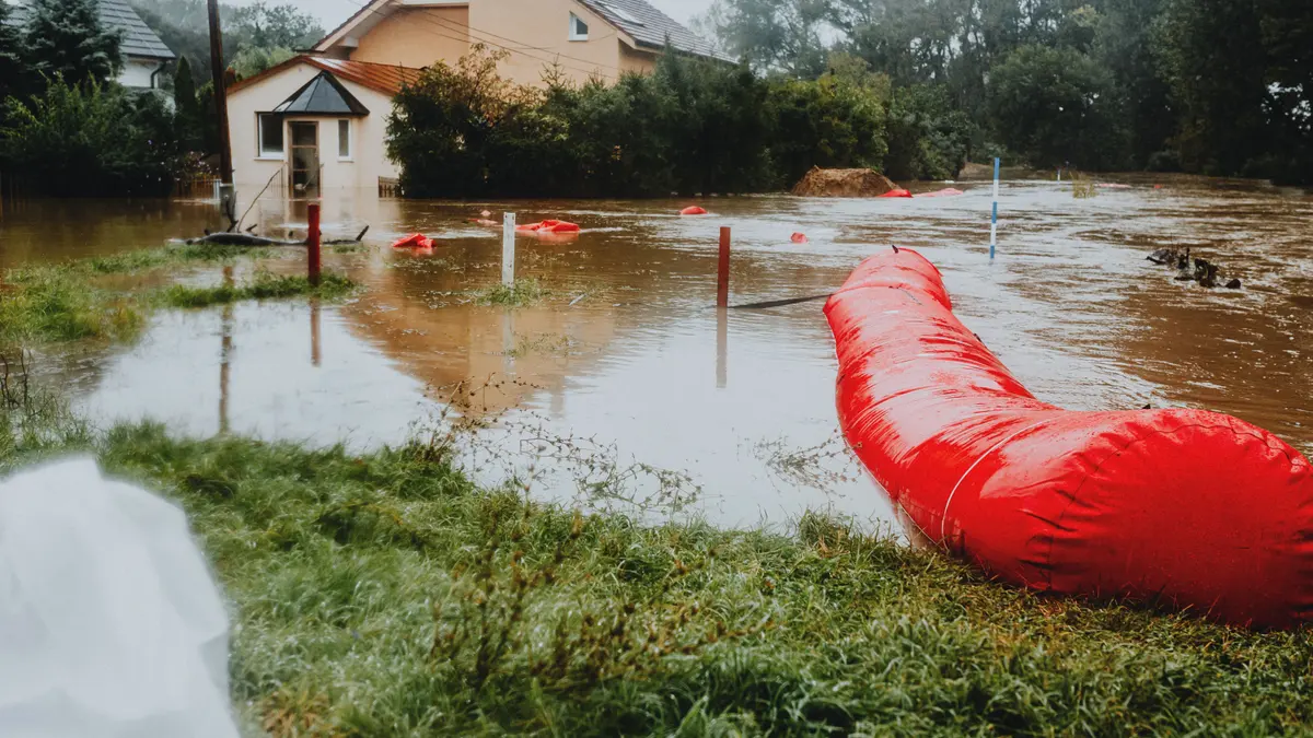 Flooded Residential Area with Red Barrier